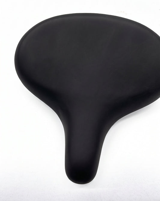 A black bicycle saddle with a smooth, matte finish, photographed from a top-down perspective on a white background.